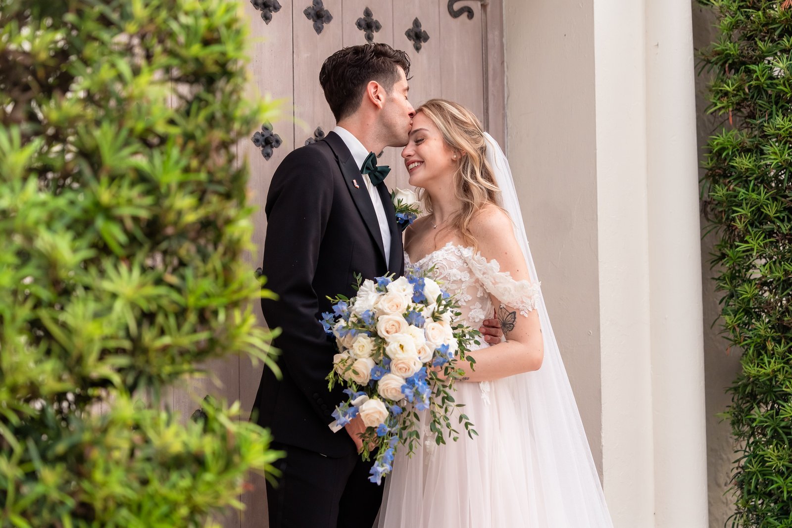 Branko kissing Mackenzie on the forehead — The Addison wedding film