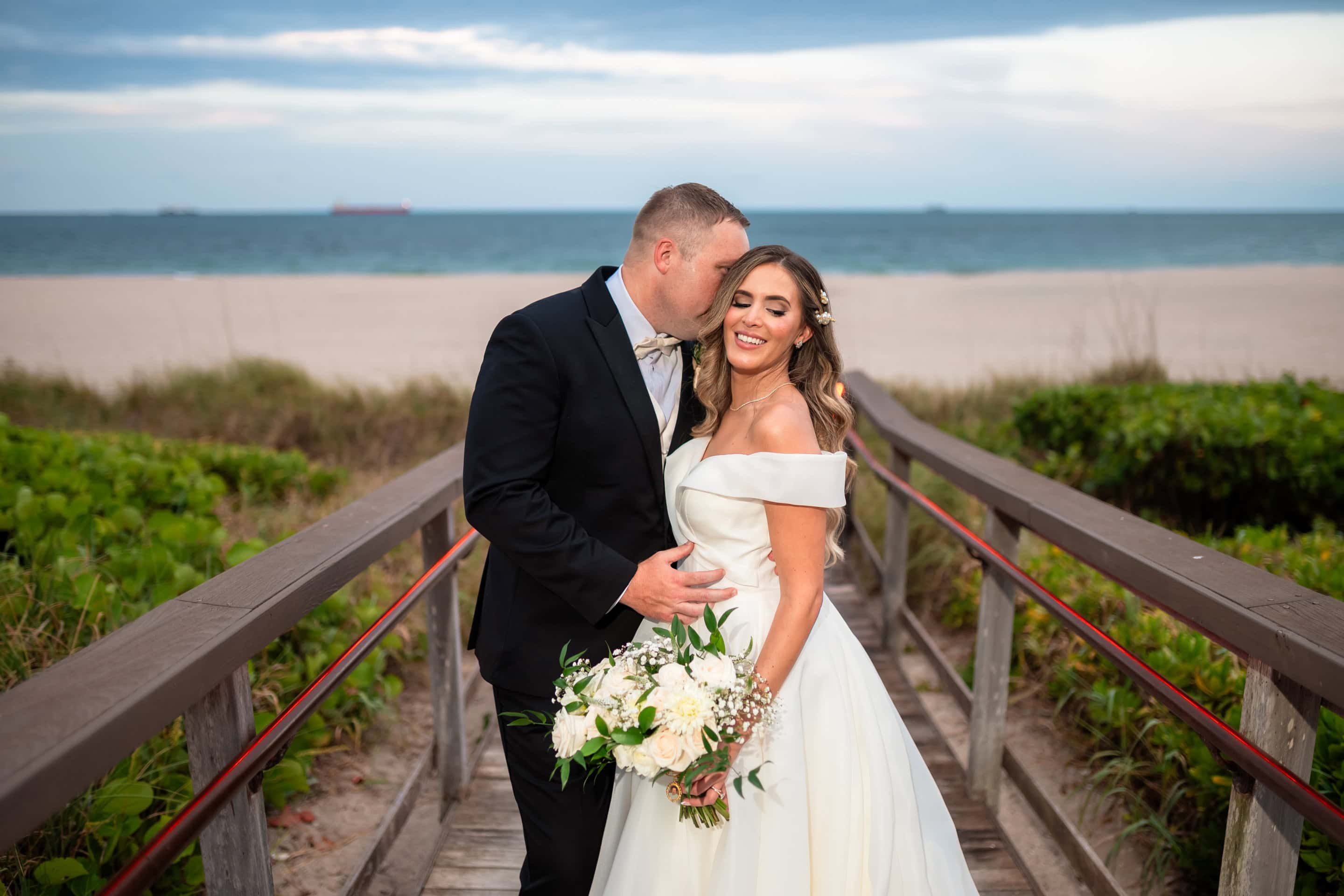 Alex and Sam sharing a portrait on the beach boardwalk at Marriott Harbor Beach