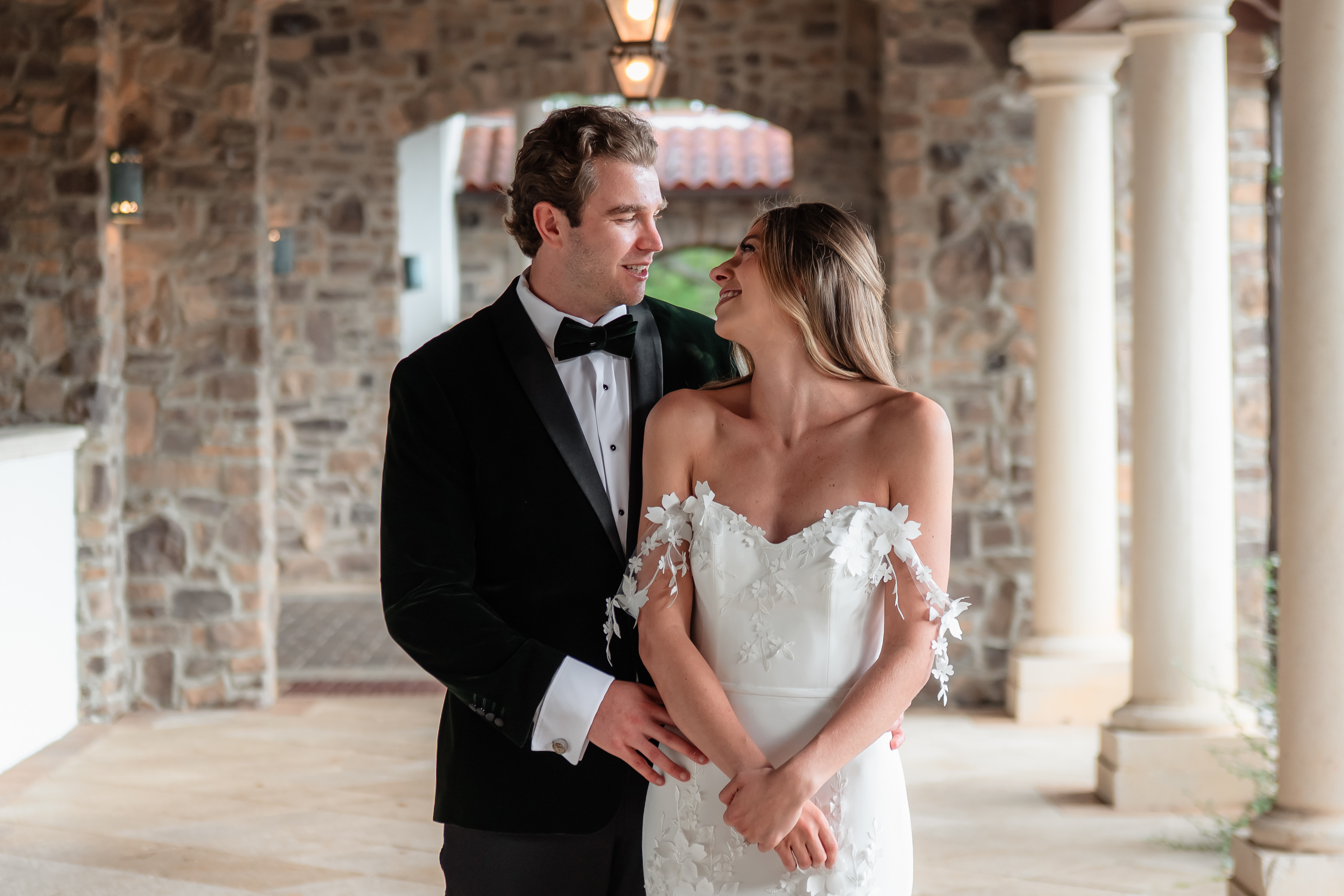 Carlie and Michael together beside the stone columns at Parkland Golf & Country Club
