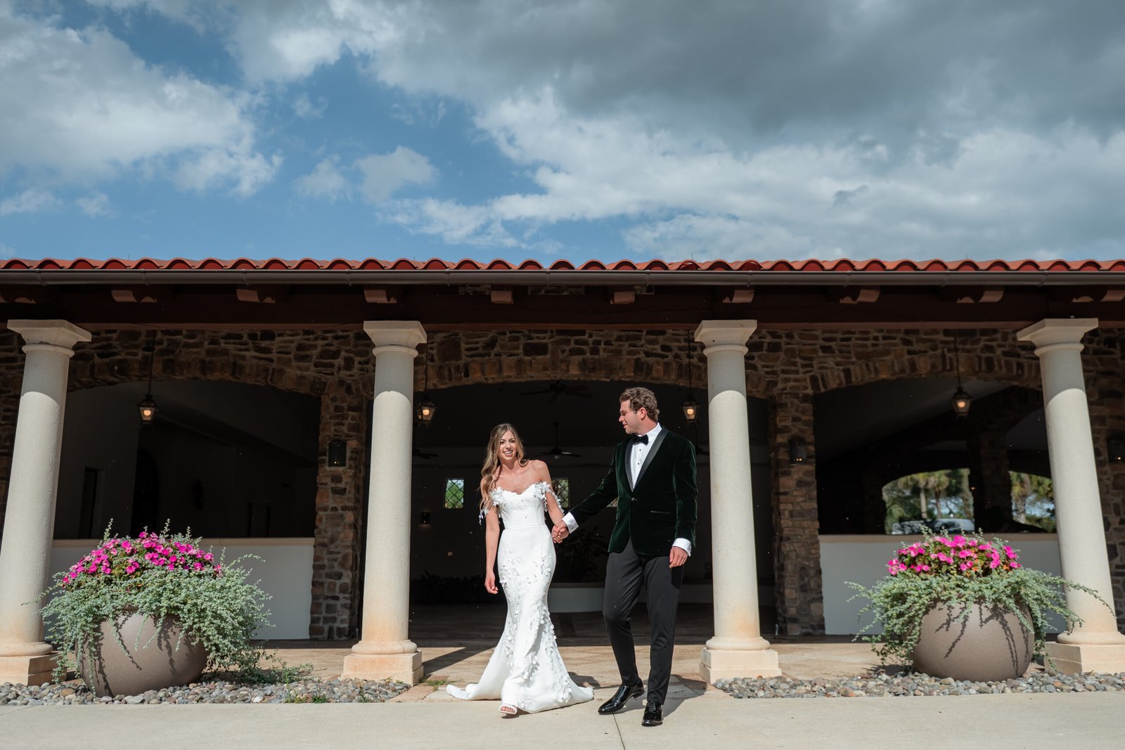 Carlie and Michael walking outside the Parkland Golf & Country Club clubhouse